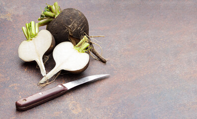 Fresh sliced black radish on a dark background.