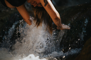 Person enjoying the refreshing water of a mountain river. Cooling off in the river for a relaxing...