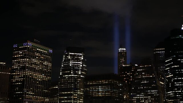 Tribute in Light, Manhattan from East river on September 11 Memorial Day. New York City downtown from ferry boat. World Trade Center. 9-11 Remembrance. Two beams in sky of United States of America USA