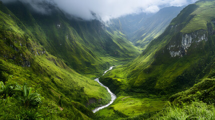 A lush green valley framed by steep mountain walls with a river winding through the landscape.
