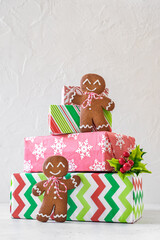 A stack of presents with two gingerbread men on top