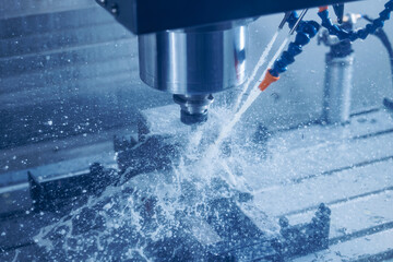 Working closeup CNC turning cutting metal Industry machine iron tools with splash cutting fluid...