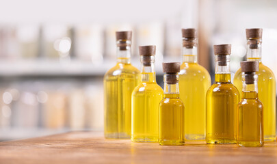 Craft yellow sunflower oil in glass bottles on white blur background