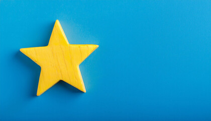 Obraz premium Yellow star isolated on blue backdrop. Banner with copy space.