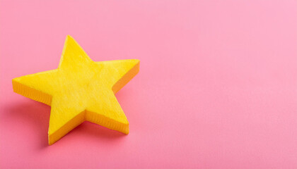 Obraz premium Yellow star isolated on pink backdrop. Banner with copy space.