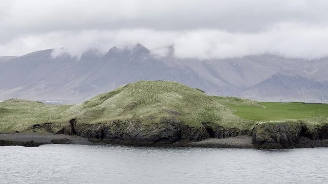Reykjavik, Iceland - slowly cruising by Videy island and mountain Esjan enjoying the stunning landscape view during a sail away