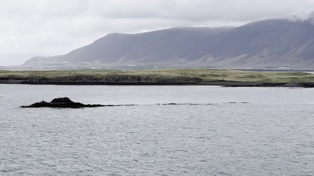 Reykjavik, Iceland - slow sail away with stunning landscape view of Videy island and Reykjav&iacute;kurborg in the background