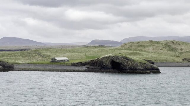 Reykjavik, Iceland - scenic cruise by Vi&eth;eyjarnaust Cabin on Videy island and Reykjav&iacute;kurborg in the background 