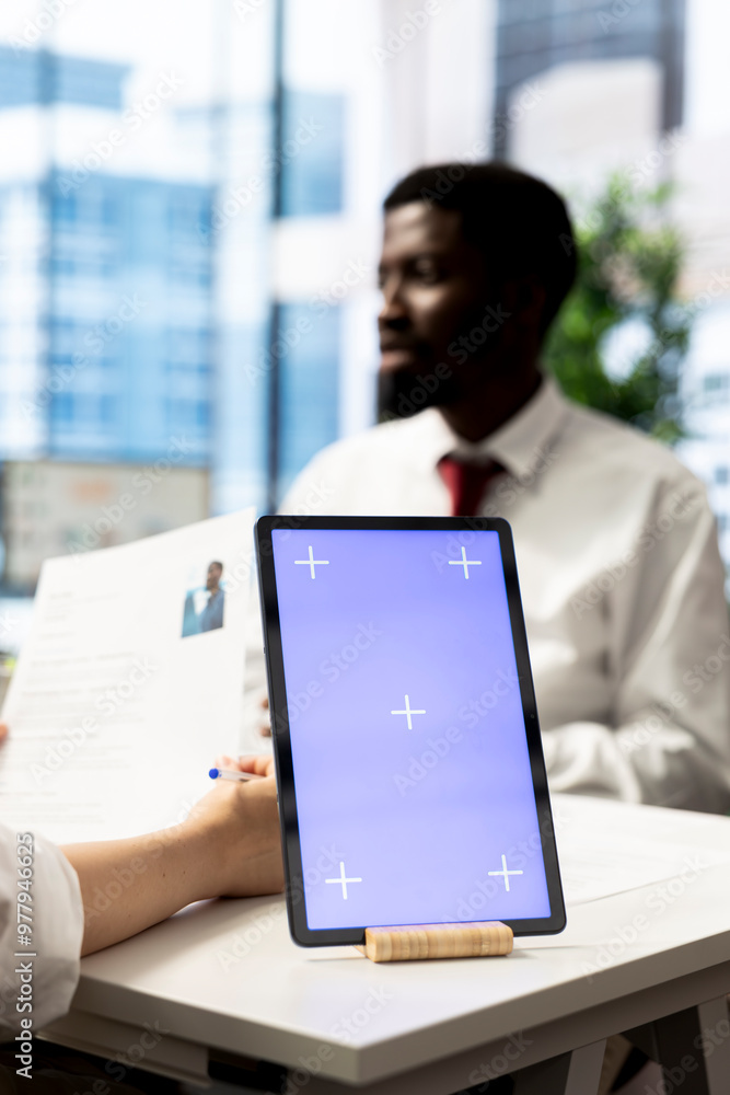 Poster hr specialist using isolated screen tablet to reviewing candidate cv, asking questions about qualifi