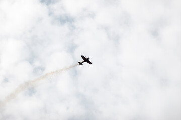 A pilot flies an aerobatic propeller plane in the sky