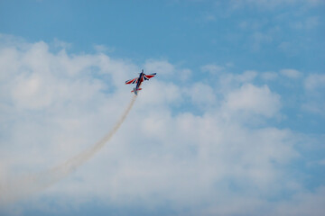 A pilot flies an aerobatic propeller plane in the sky