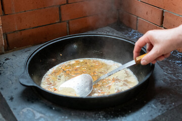national Central Asian dish pilaf is cooked over an open fire with vegetables and fruits.