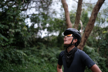 a young woman taking breather during her bike ride outdoors