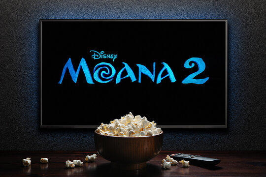 Moana 2 trailer or movie on TV screen. TV with remote control and popcorn bowl. Astana, Kazakhstan - September 17, 2024.