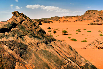 Rock formations in Tadrart Rouge, Tassili N'Ajjer National Park. Sahara desert, orange sand and rocks. Holidays and travel in Algeria. Sahara, Algeria, Africa.