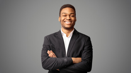 Millennial Entrepreneur. Confident afro man crossing arms, standing over white studio background. Panorama, free space