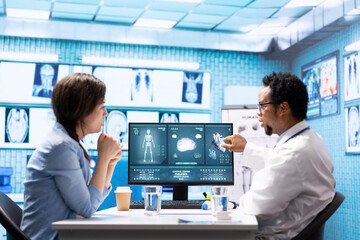 Medic expert showing the x ray imaging test results to patient at check up, discussing about...