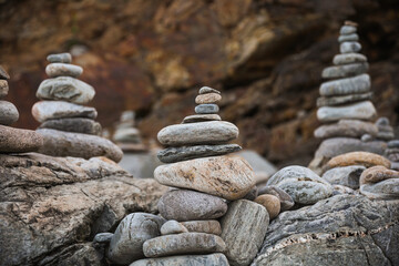 serene beach scene with smooth rocks stacked in a balanced formation. The tranquil atmosphere evokes a sense of zen, harmony, and peace, symbolizing balance and mindfulness in nature