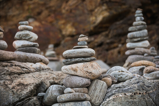 serene beach scene with smooth rocks stacked in a balanced formation. The tranquil atmosphere evokes a sense of zen, harmony, and peace, symbolizing balance and mindfulness in nature