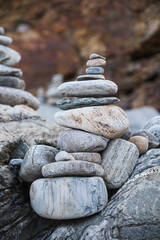 serene beach scene with smooth rocks stacked in a balanced formation. The tranquil atmosphere evokes a sense of zen, harmony, and peace, symbolizing balance and mindfulness in nature