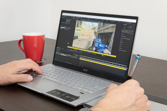 Close up to a man working on Adobe Afer Effects software into a modern acer laptop