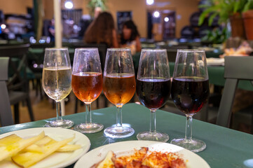 Tasting of sherry wines from barrels, fino, manzanilla, olorosso, amontillado jerez wines with traditional Andalusian tapas in old tavern, Sanlucar de Barrameda, Cadiz, Andalusia, Spain
