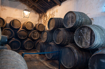 Solera system in old Andalusian wine cellar, process for aging sherry wine in barrels, fino, manzanilla, olorosso, amontillado jerez fortified wine, Sanlucar de Barrameda, Cadiz, Andalusia, Spain