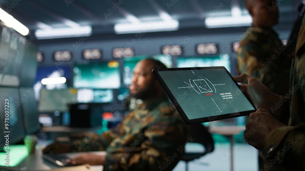 Aufkleber military agent working in control room, using software on tablet, analyzing aerial reconnaissance da