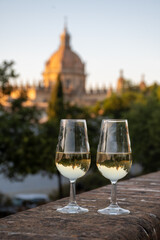 Sherry wine glasses and old bogedas jerez wine cellars on background in Jerez de la Frontera, wine glasses outdoor, cityview, Andalusia, Spain