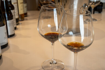 Tasting of sweet Bordeaux white wine in Sauternes, left bank of Gironde Estuary, France. Glasses of white sweet French wine served in restaurant