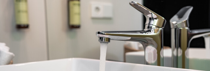 Water flowing from an open faucet, ecological concept