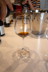 Tasting of sweet Bordeaux white wine in Sauternes, left bank of Gironde Estuary, France. Glasses of white sweet French wine served in restaurant