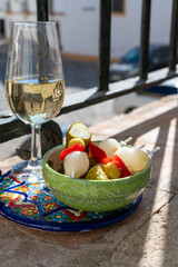Sherry fino, manzanilla, jerez fortified wine made from palomino white grape served with tapa in old house in Jerez de la Frontera, Cadiz, Andalusia, Spain