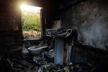 Burnt house interior. Burned burnt bathroom, Fused remains of furniture