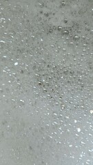 full frame of tiny reflective sudsy water bubbles