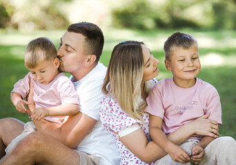 Kiss delivery for dad and mom. Cropped shot of a young family spending time together outdoors.