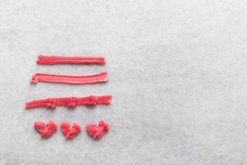 Pink buttercream piped using a open star nozzle, buttercream piped using a small open star piping tip on a white countertop