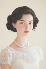 Elegant young woman in vintage dress with pearls indoors