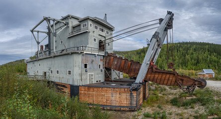 Old historic dredging machine used in gold mining at Dawson City, Yukon, Canada