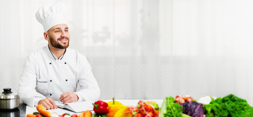 Professional Chef Man On Job Interview Talking With Woman Sitting In Restaurant Kitchen. Selective Focus