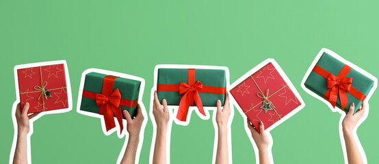Female hands holding Christmas gift boxes on green background