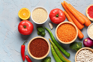Different fresh vegetables and cereals on blue background