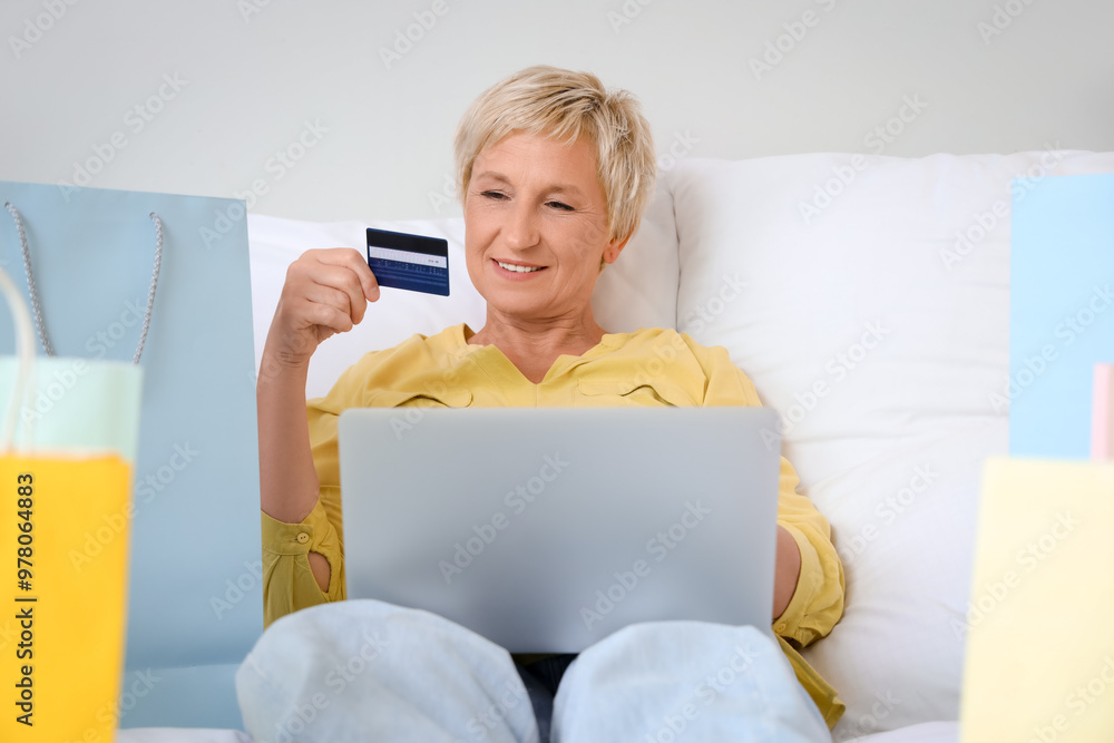 Canvas Prints mature woman with credit card and laptop shopping online in bedroom