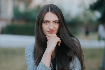 Portrait of a Woman Outdoors Looking at the Camera with Suspicion