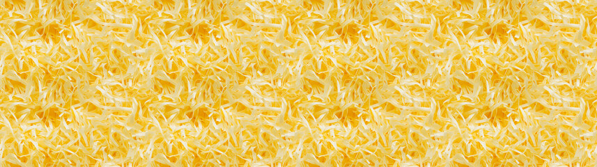 Obraz premium shredded paper filler in yellow color with thin, delicate strips, shredded paper filler texture background