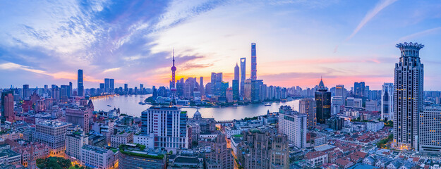 Aerial view of modern city skyline and buildings at sunrise in Shanghai