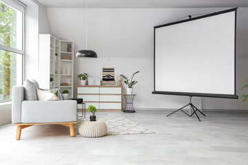 Interior of light living room with sofa and projector screen
