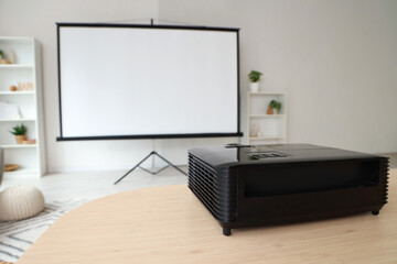 Video projector on dining table in light room, closeup