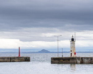 14 September 2024. Anstruther,Fife,Scotland. This is Chalmers Lighthouse at the exit of Anstruther Harbour on a grey cloudy morning.