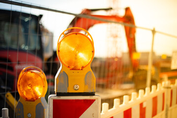 Warning light on a construction site. Crane in background. Day, outside, sun, nobody.